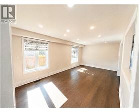 A sunny room with a window and wooden floors.