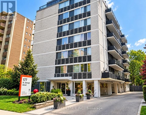 A tall apartment building with the number 177 on a sign in front of it.