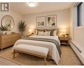 A bedroom with a bed, nightstands, and a rug.