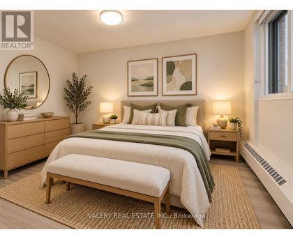 A bedroom with a bed, nightstands, and a rug.