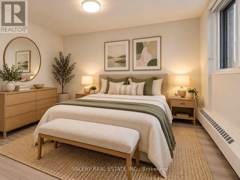 A bedroom with a bed, nightstands, and a rug.