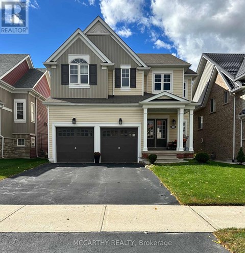 A two-story house with a garage is for sale by McCarthy Realty in Brokerage.