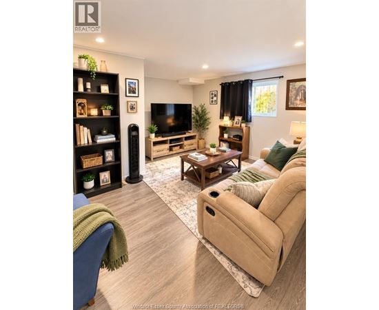 A living room with a blue couch and a beige sofa.