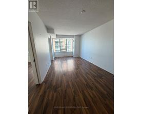 A room with wooden floors and a window.
