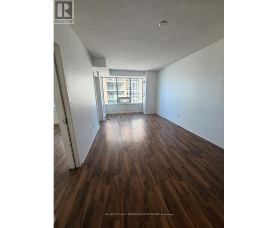 A room with wooden floors and a window.