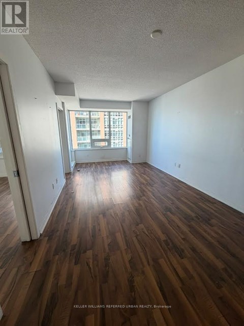 A room with wooden floors and a window.