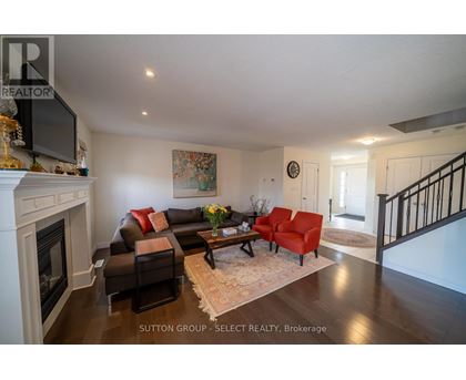 A living room with a fireplace and a painting on the wall.