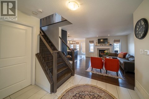 A living room with a staircase and a couch.