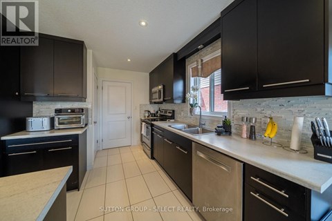 A kitchen with black cabinets and a white countertop.