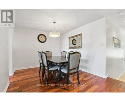 A dining room with a table set for four.