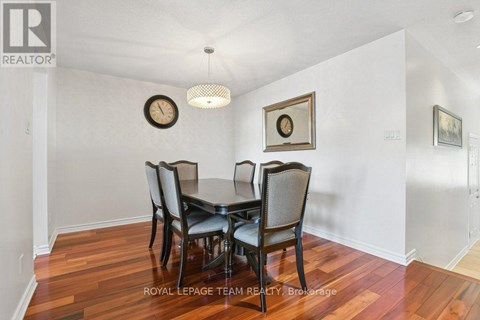 A dining room with a table set for four.