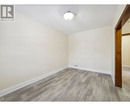 A room with a wooden floor and a white ceiling.