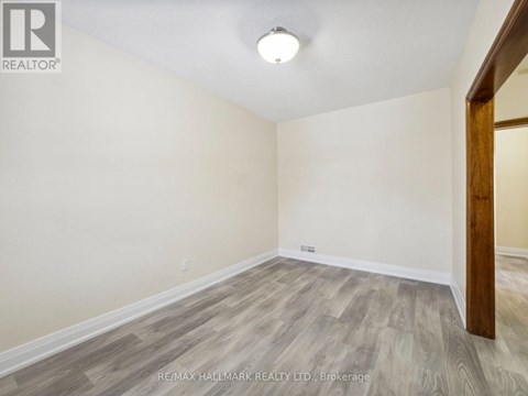 A room with a wooden floor and a white ceiling.