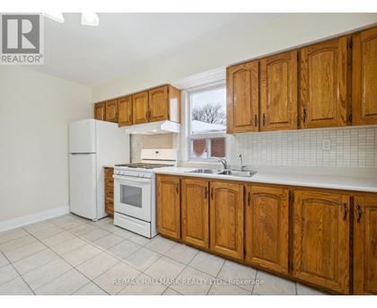 A kitchen with wooden cabinets and white appliances.