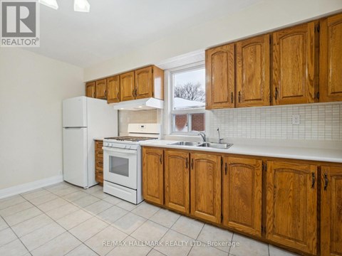 A kitchen with wooden cabinets and white appliances.
