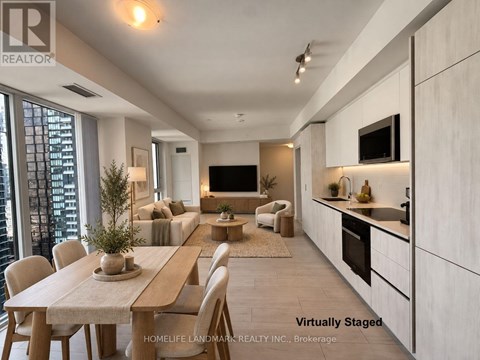 A modern kitchen with a dining table and chairs.