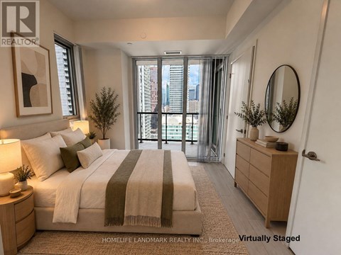 A bedroom with a large bed and a view of the city through the window.
