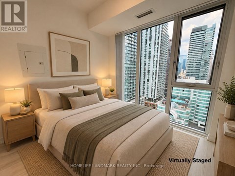 A bedroom with a large bed and a view of the city.