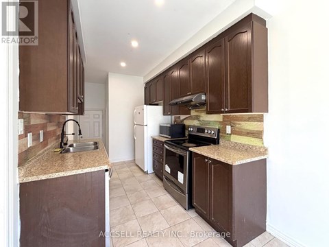 A kitchen with brown cabinets and a granite counter top.