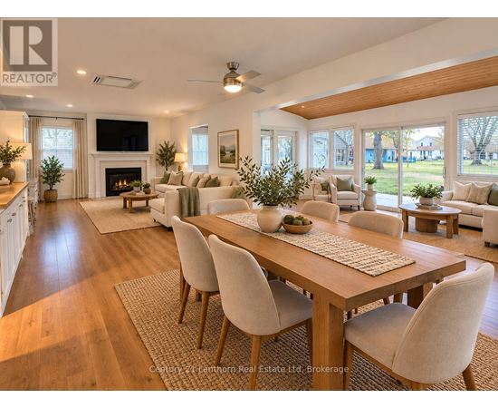 A well-lit, spacious living room with a large dining table and chairs.