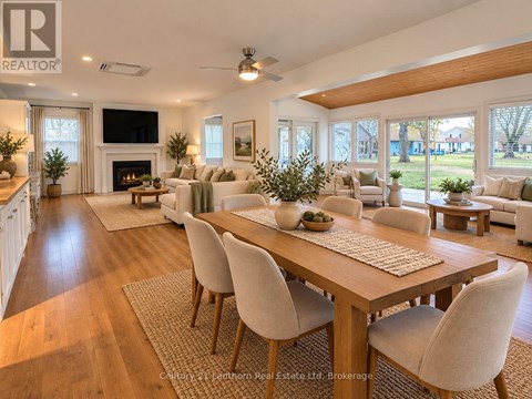 A well-lit, spacious living room with a large dining table and chairs.