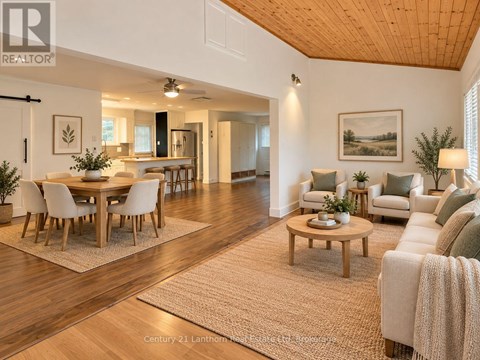 A well-lit, spacious living room with a dining area and a couch.