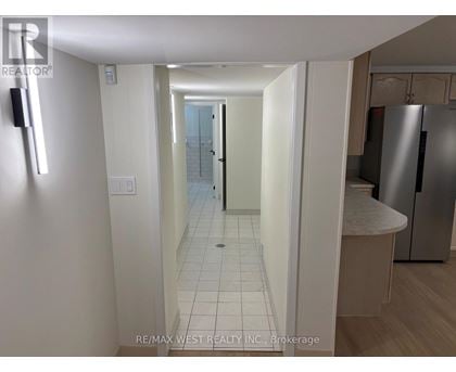 A hallway with a white door and a white wall.