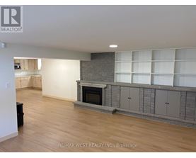 A living room with a fireplace and built-in shelves.