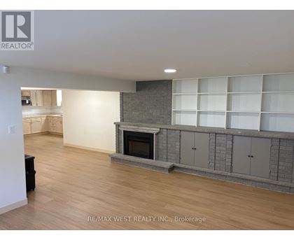 A living room with a fireplace and built-in shelves.