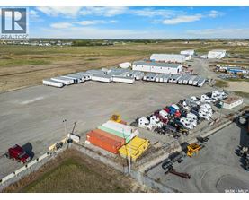 A large industrial area with a variety of vehicles and buildings.