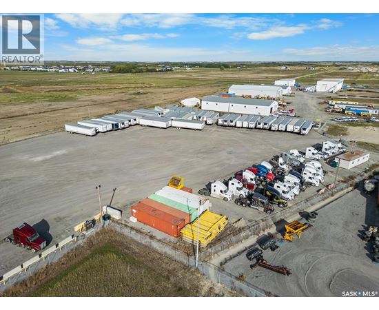 A large industrial area with a variety of vehicles and buildings.