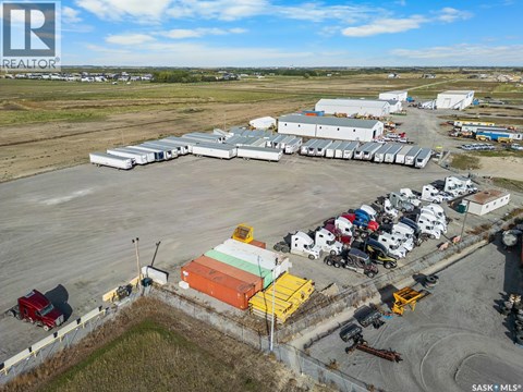 A large industrial area with a variety of vehicles and buildings.