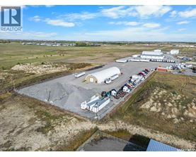 An aerial view of a large industrial area with buildings and vehicles.