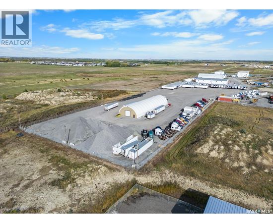 An aerial view of a large industrial area with buildings and vehicles.