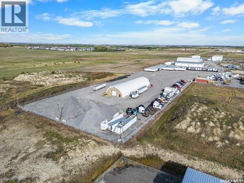An aerial view of a large industrial area with buildings and vehicles.