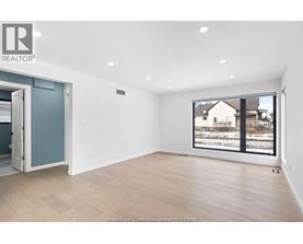 A room with a large window overlooking a snowy landscape.
