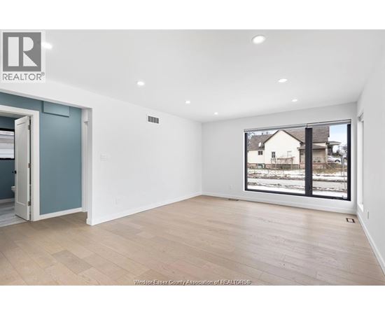 A room with a large window overlooking a snowy landscape.