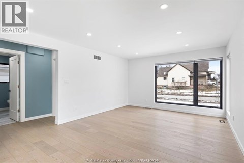 A room with a large window overlooking a snowy landscape.