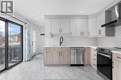 A kitchen with white cabinets and a black stove top oven.