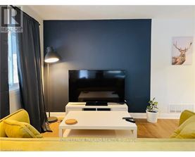 A living room with a flat screen TV and a coffee table.