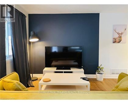 A living room with a flat screen TV and a coffee table.