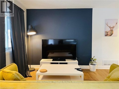 A living room with a flat screen TV and a coffee table.