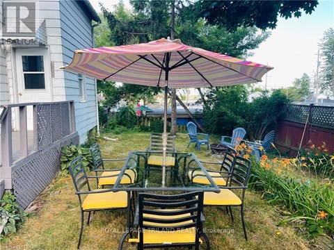 A patio with a table and chairs under an umbrella.