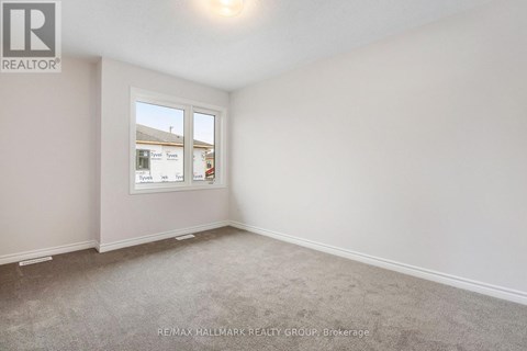 A room with a window showing a view of other buildings.