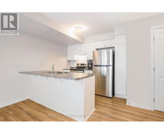 A kitchen with white cabinets and a granite countertop.