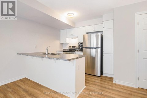 A kitchen with white cabinets and a granite countertop.