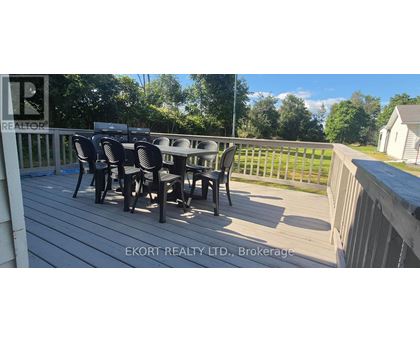 A deck with a table and chairs is shown.