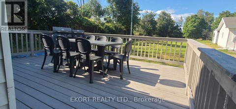 A deck with a table and chairs is shown.