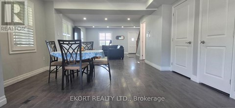 A dining room with a table and chairs is shown in the image.