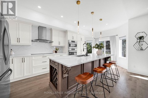 A modern kitchen with white cabinets and a central island.